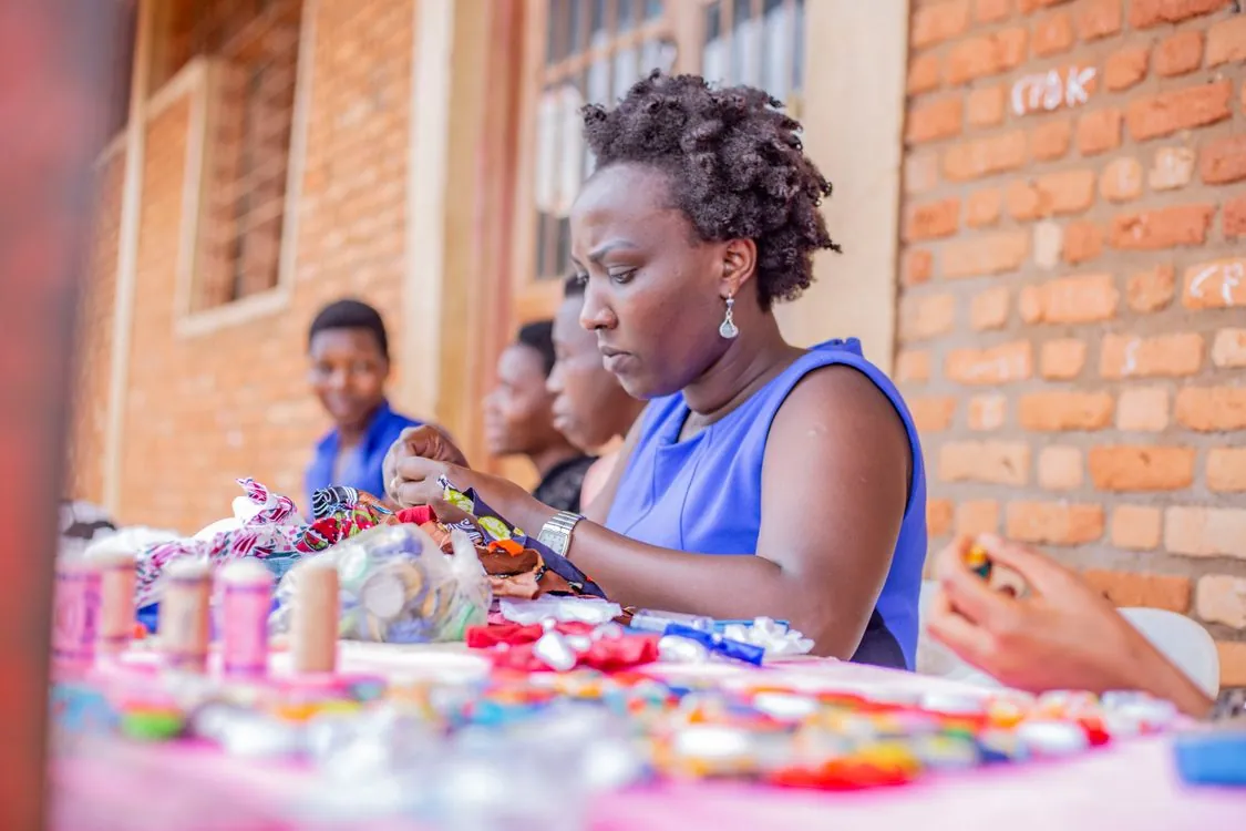 African craft entrepreneur working at a colorful market stall