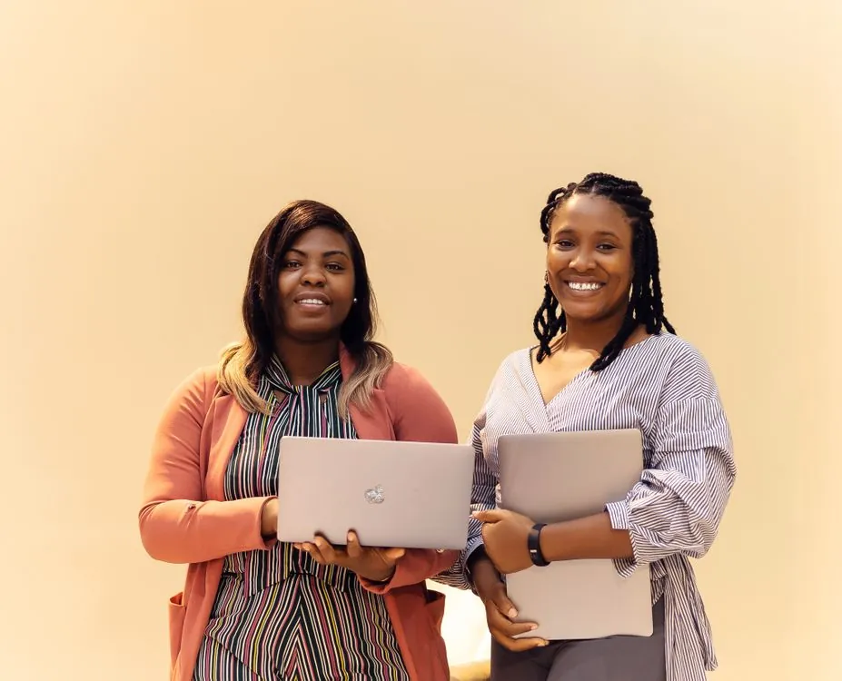 African businesswomen collaborating with laptops in a Lagos office